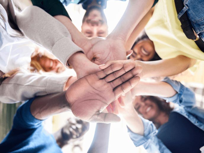 Image showing a group of people laying hands one on other