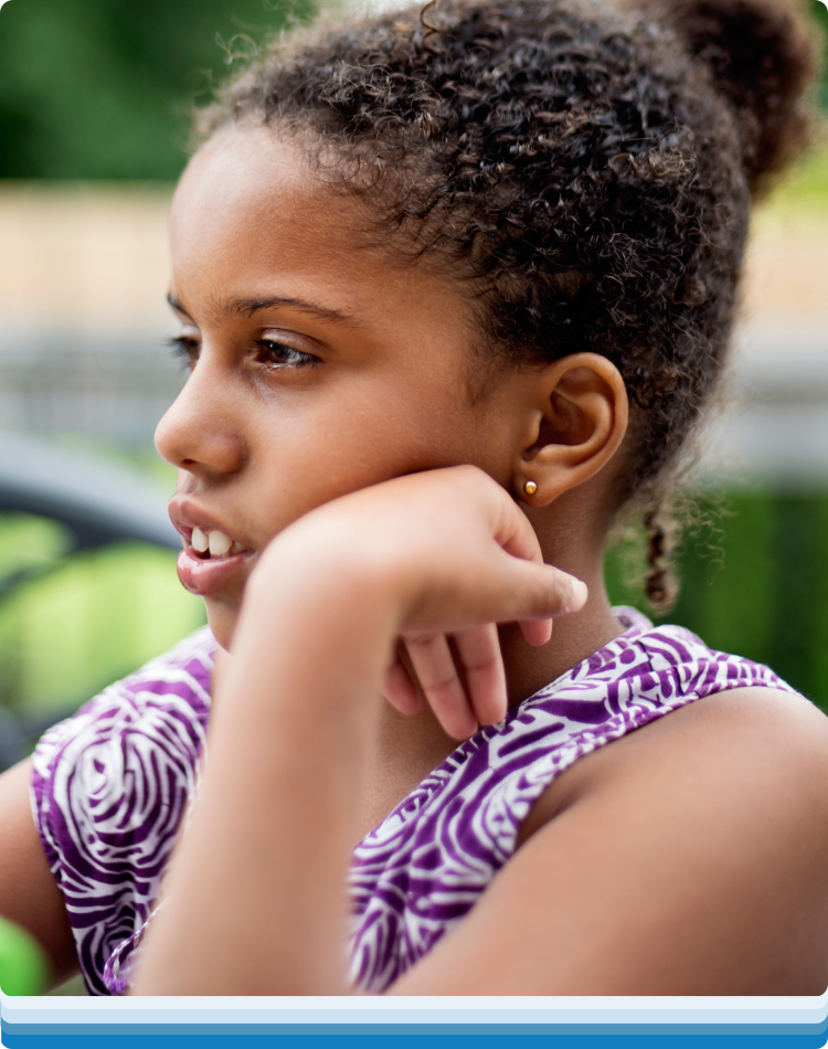 Child sitting outside during ABA therapy near me