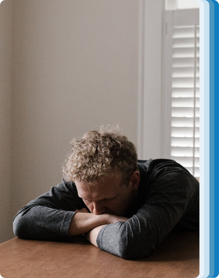 Person laying on their arms feeling depressed before they go to counseling for depression