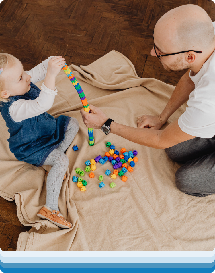 Therapist and child busy playing with building blocks during therapy for kids near me