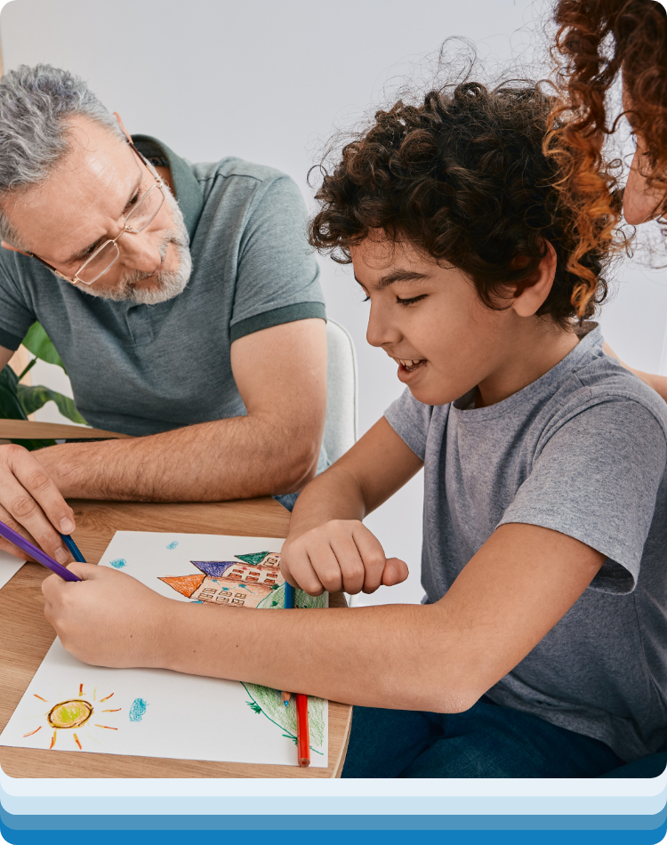 Therapist and kid busy drawing and chatting during a therapy for kids near me consultation